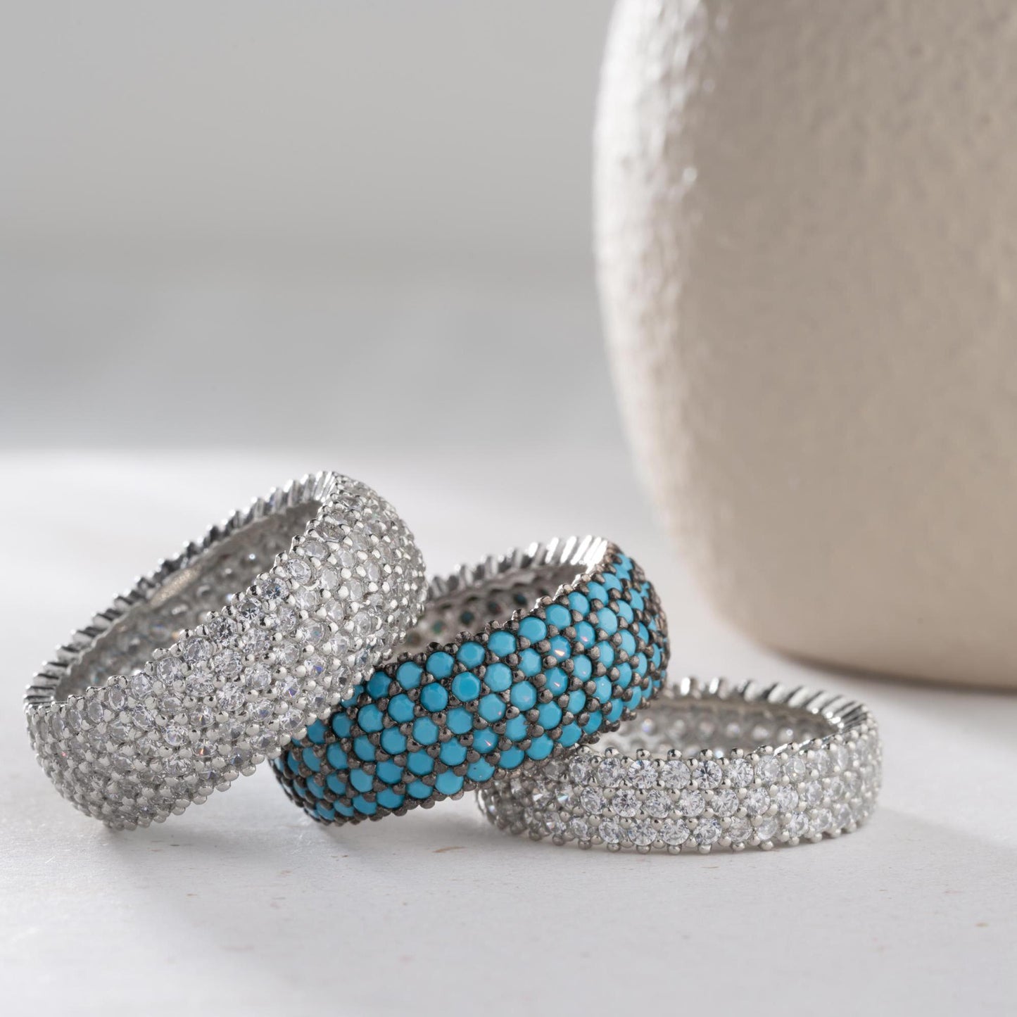 Full eternity band ring featuring pave cubic zirconia stones in clear and turquoise options, set in 925 sterling silver. A versatile, stackable piece perfect for gifting or personal wear.