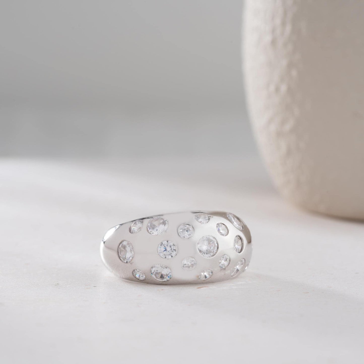 Elegant pave dome ring featuring dazzling cubic zirconia stones, crafted in 925 sterling silver with 14K gold plated options. A luxurious, adjustable statement ring for women.