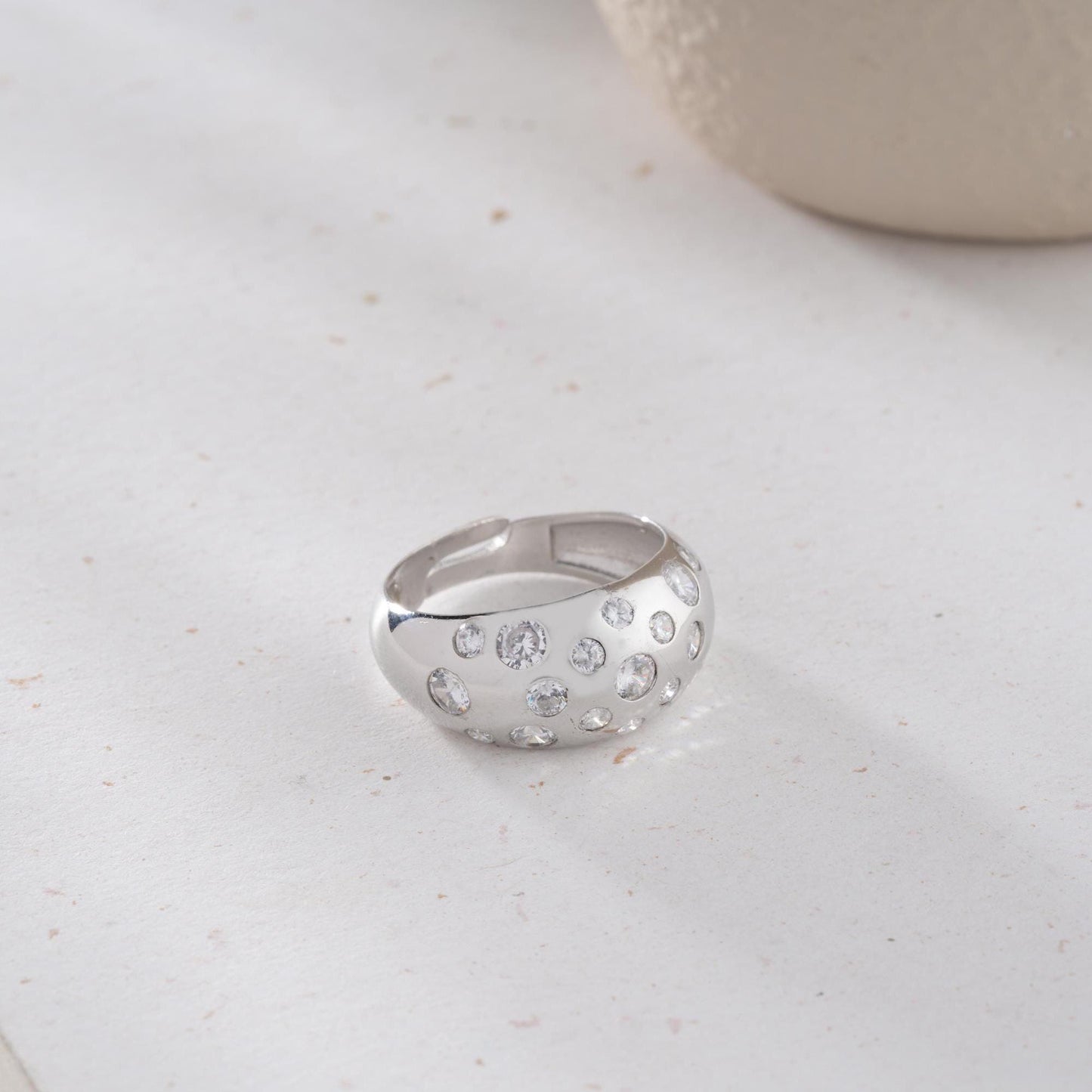 Elegant pave dome ring featuring dazzling cubic zirconia stones, crafted in 925 sterling silver with 14K gold plated options. A luxurious, adjustable statement ring for women.
