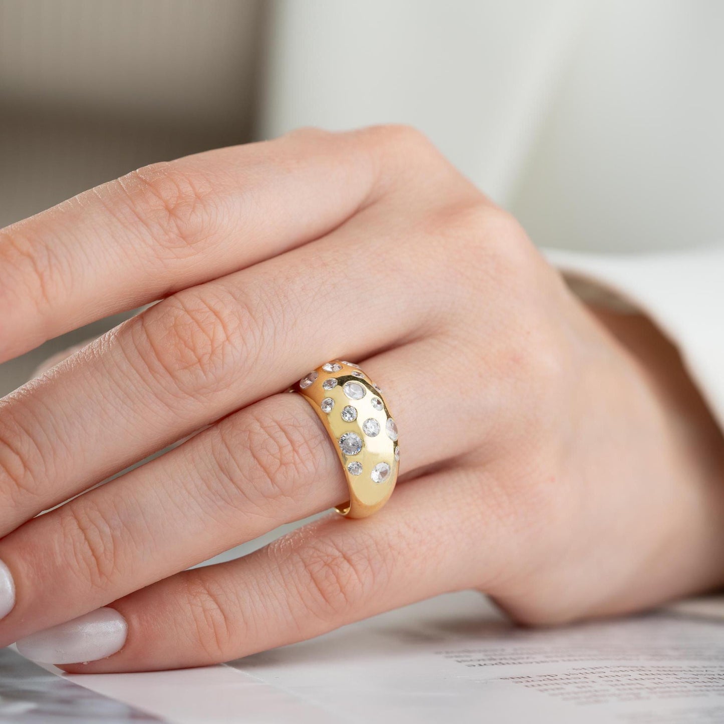 Elegant pave dome ring featuring dazzling cubic zirconia stones, crafted in 925 sterling silver with 14K gold plated options. A luxurious, adjustable statement ring for women.