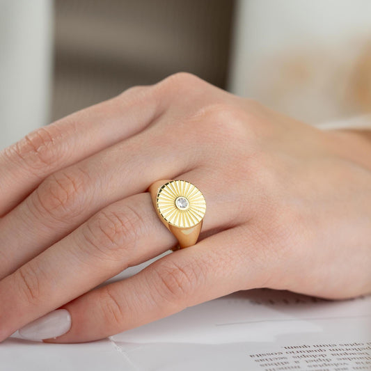 Sunburst engraved statement ring in 925 sterling silver and 14K gold plating with a center cubic zirconia stone.