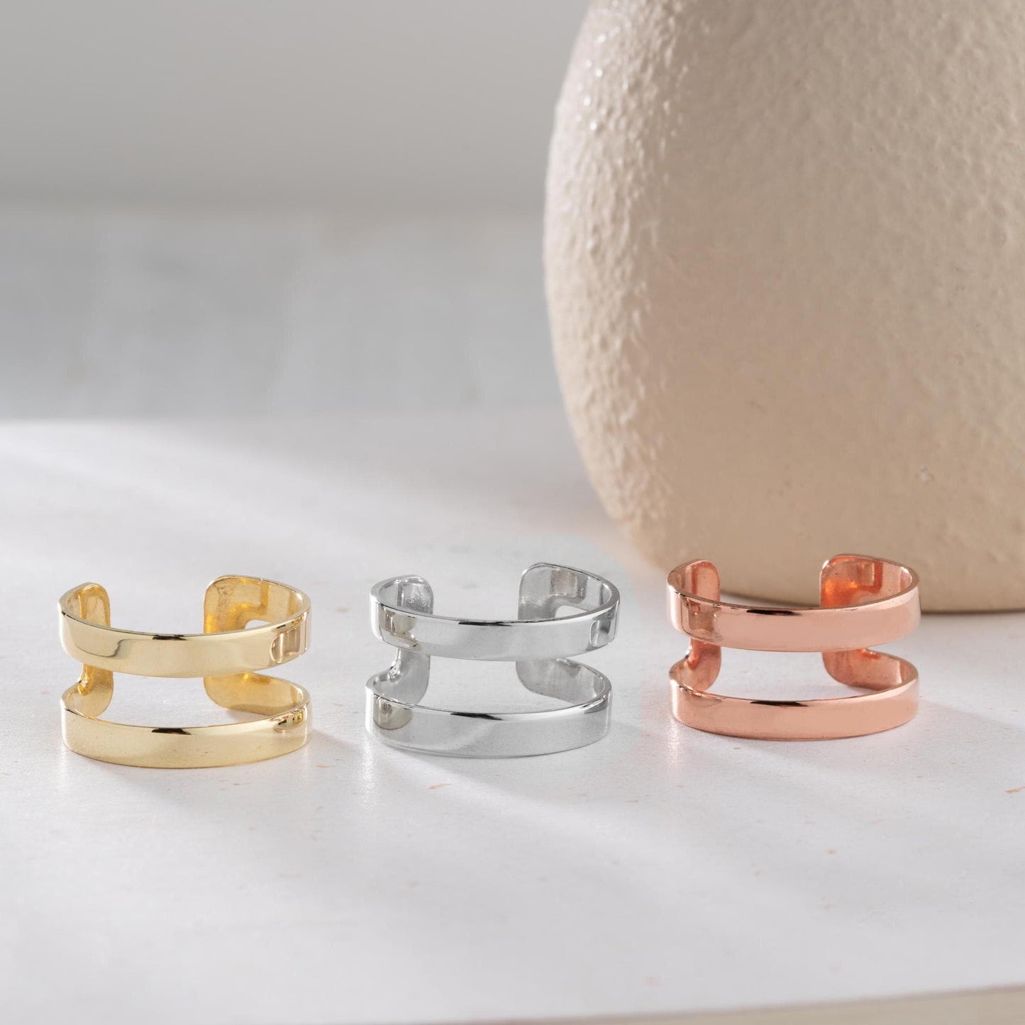 A sleek minimalist double-band ring, handcrafted from 925 sterling silver with 14K gold and rose gold plated options. A perfect stackable jewelry piece for everyday wear or as a gift for her.