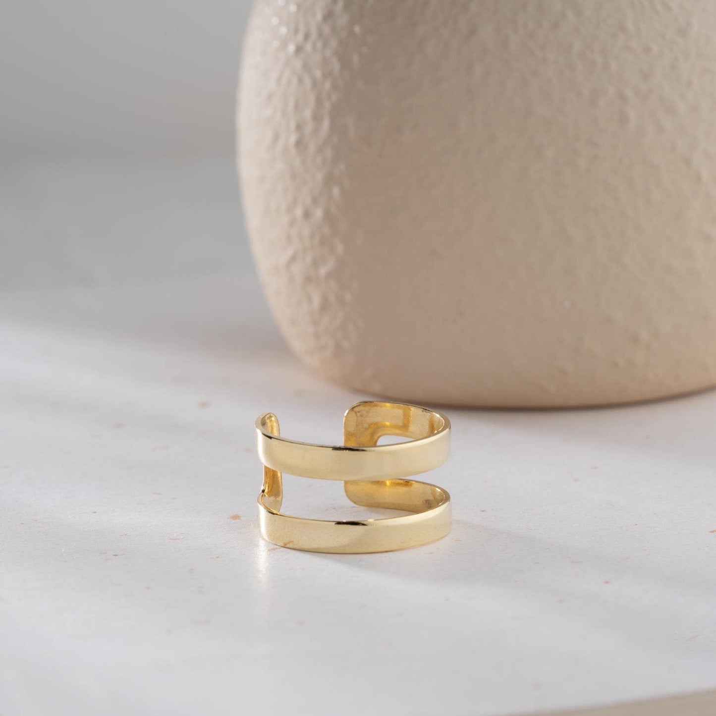 A sleek minimalist double-band ring, handcrafted from 925 sterling silver with 14K gold and rose gold plated options. A perfect stackable jewelry piece for everyday wear or as a gift for her.