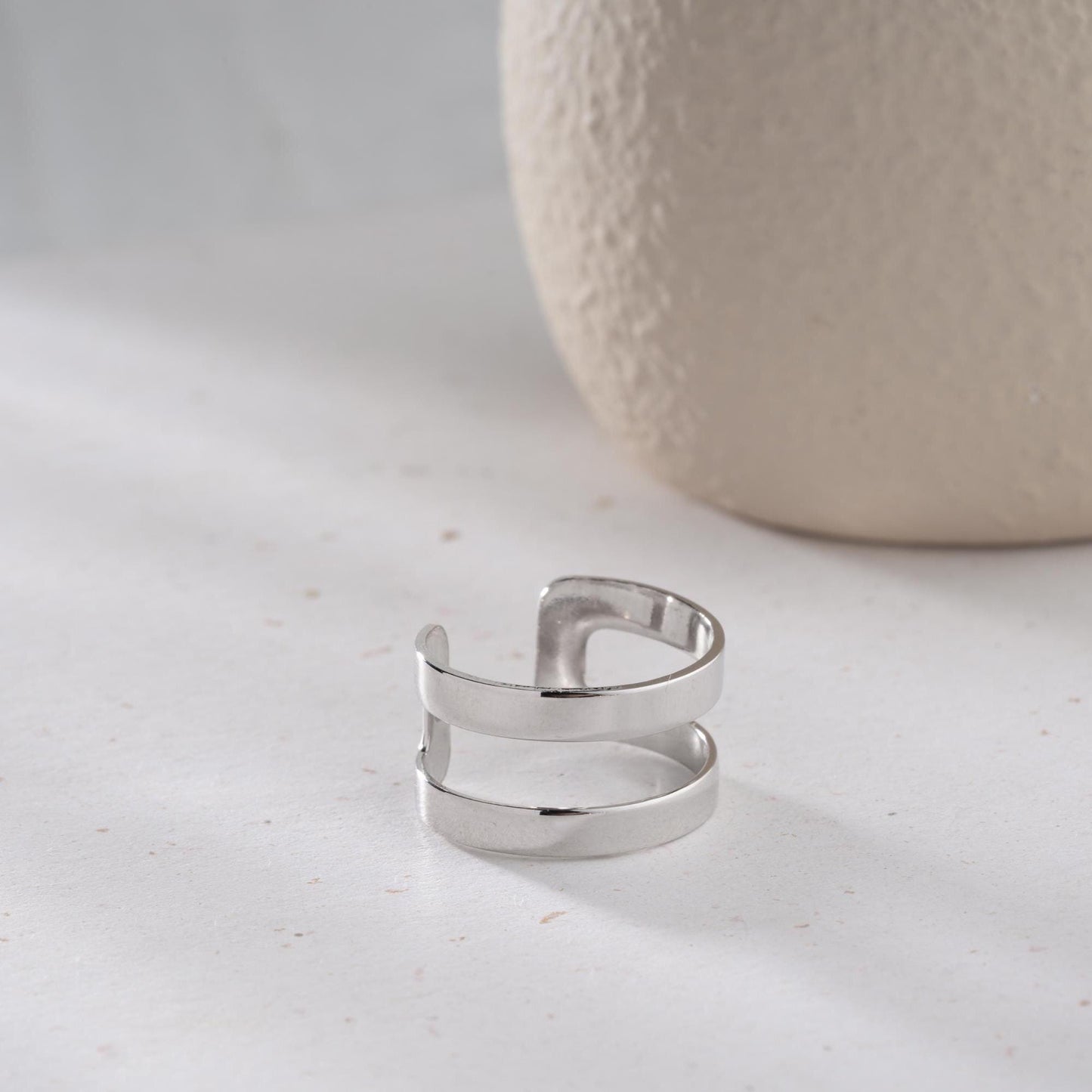 A sleek minimalist double-band ring, handcrafted from 925 sterling silver with 14K gold and rose gold plated options. A perfect stackable jewelry piece for everyday wear or as a gift for her.