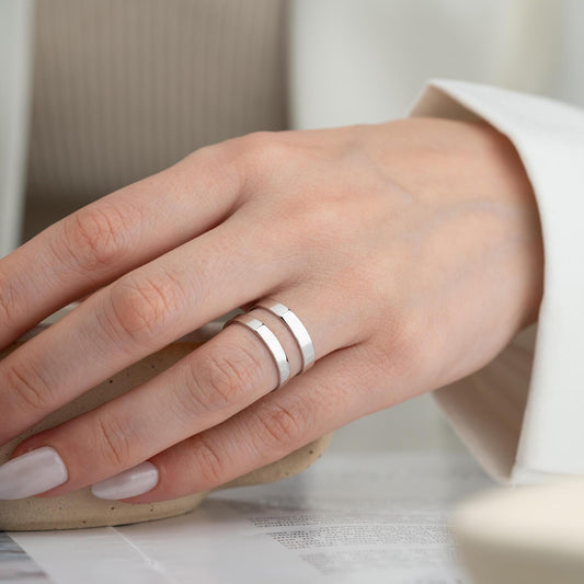 A sleek minimalist double-band ring, handcrafted from 925 sterling silver with 14K gold and rose gold plated options. A perfect stackable jewelry piece for everyday wear or as a gift for her.