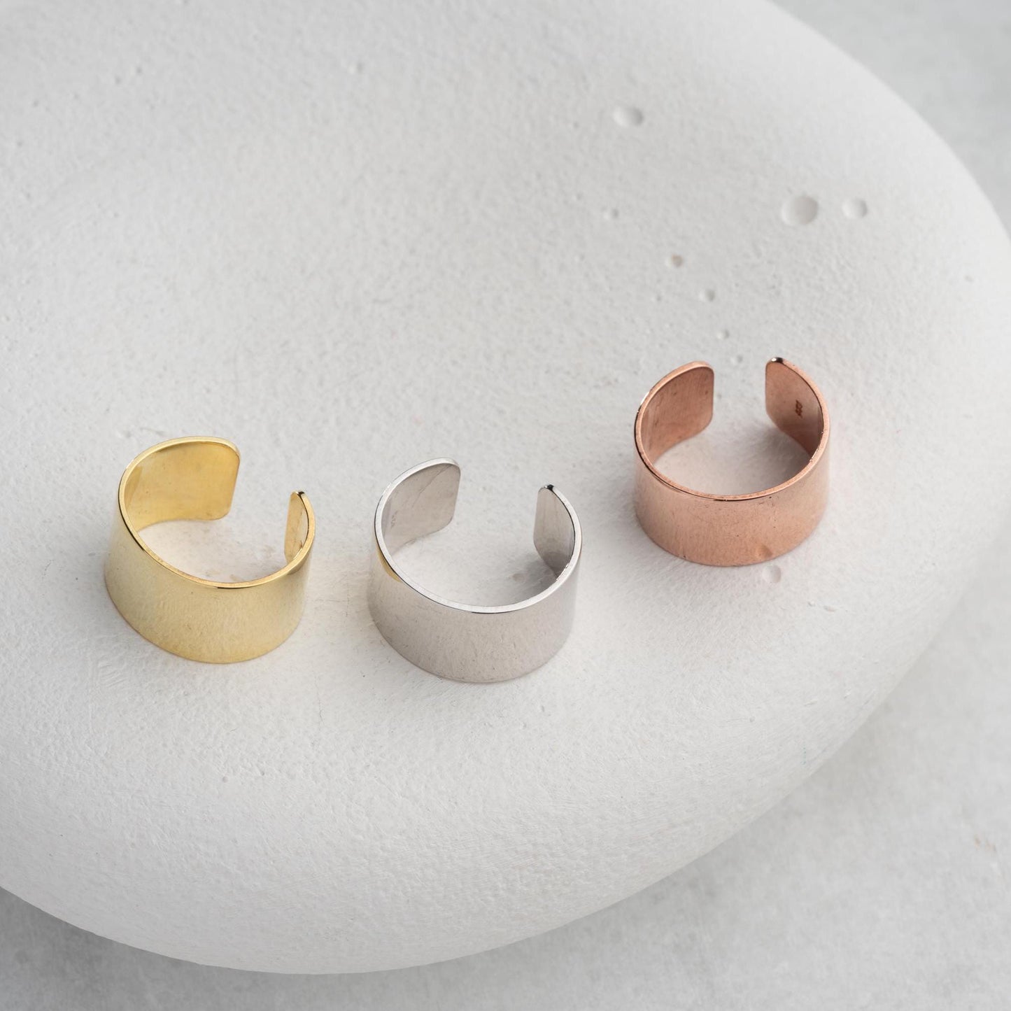 A bold, wide band open ring crafted from 925 Sterling Silver, available in gold and rose gold finishes. Adjustable design for comfort and style, ideal for gifting.