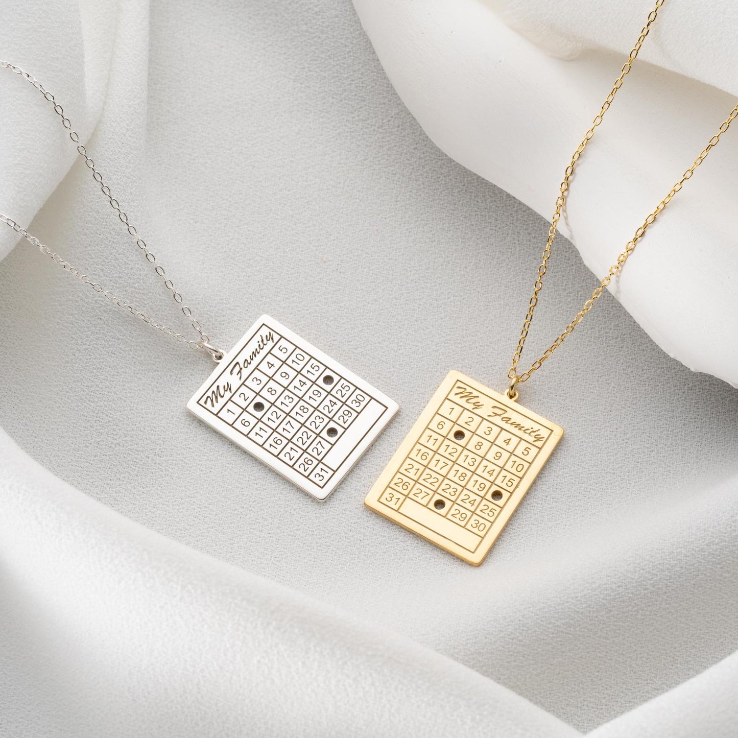 A personalized calendar necklace with a custom date engraving, available in sterling silver and gold plated finishes. The perfect anniversary, birthday, or wedding gift for her.