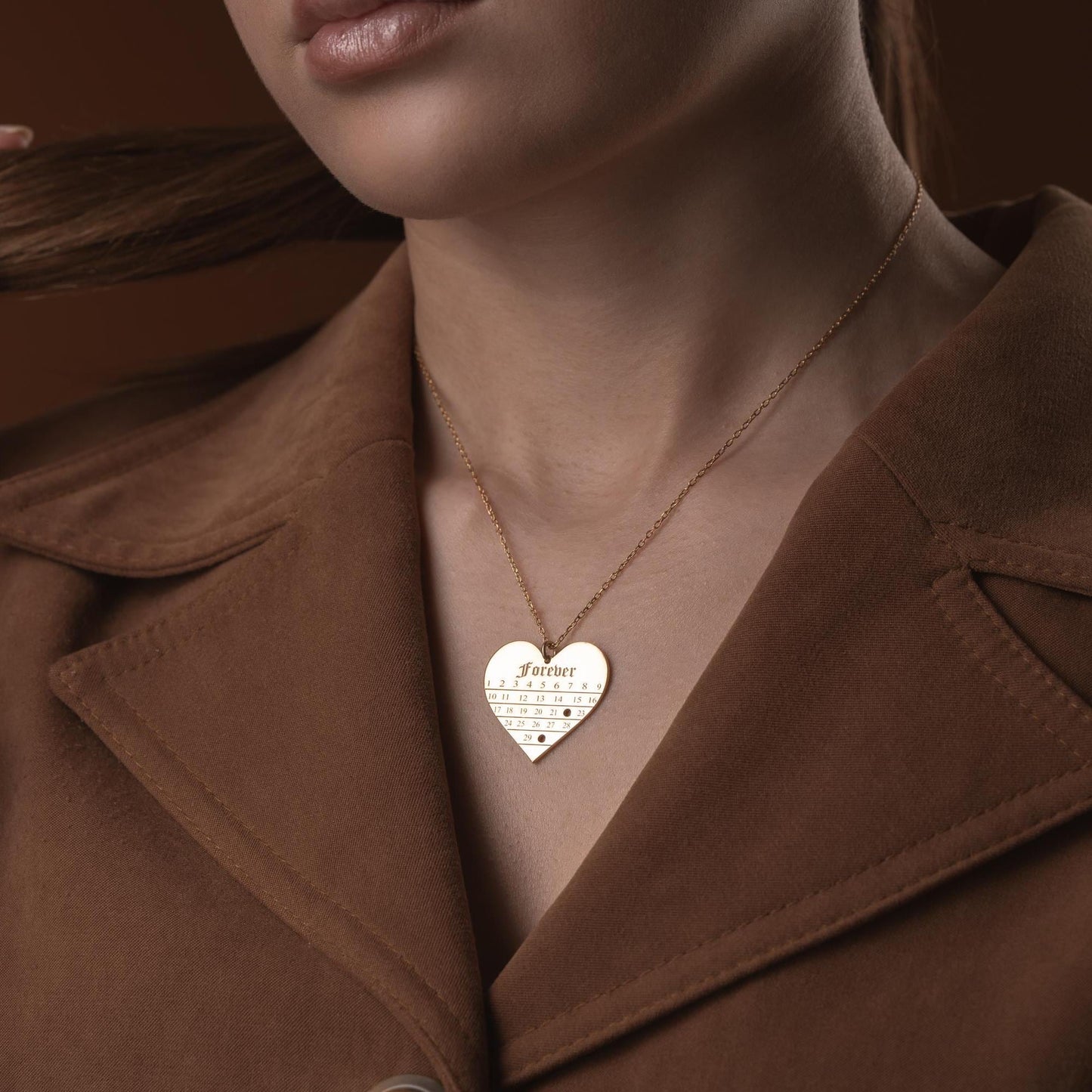 A personalized heart-shaped calendar necklace with a custom date engraving, available in sterling silver and gold plated finishes. Perfect for anniversaries, weddings, or Valentine's Day.