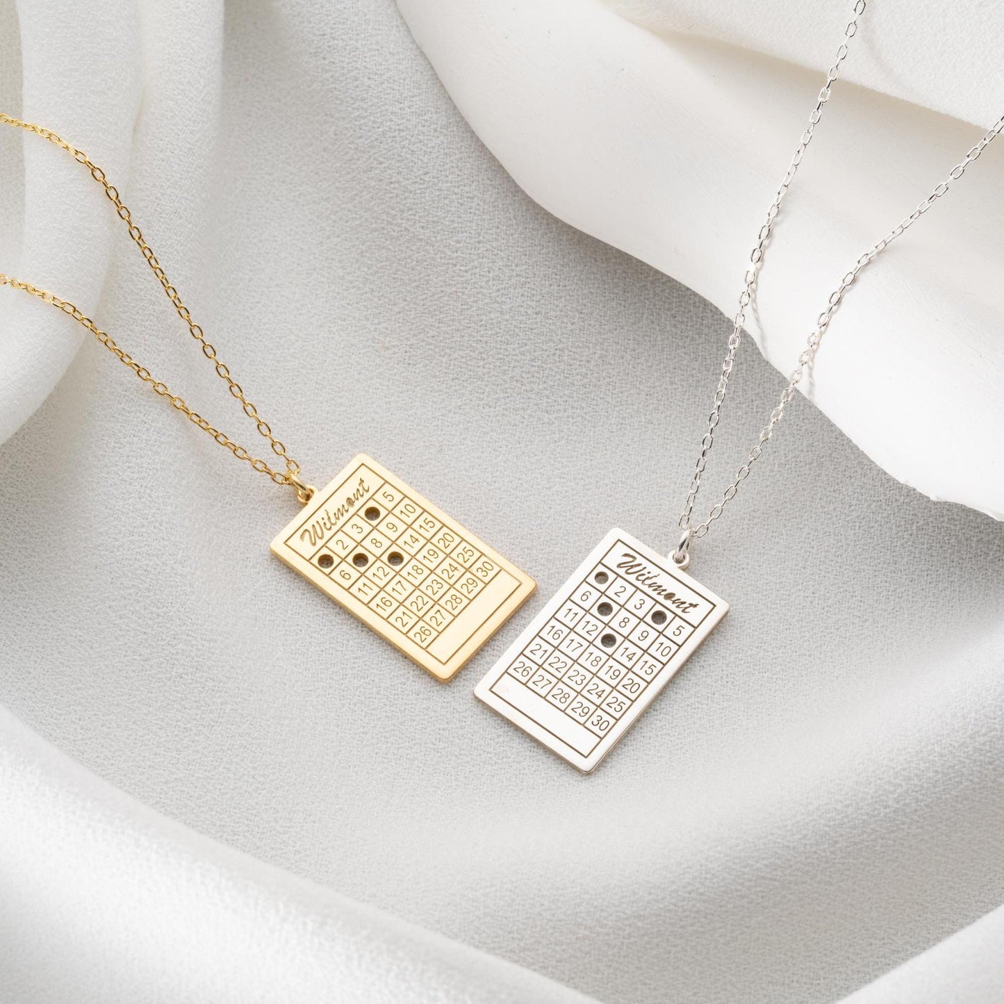A rectangular calendar pendant necklace, engraved with a custom date and name, crafted from 925 Sterling Silver or 14K Gold Plated. Ideal for anniversaries, weddings, and birthday gifts.