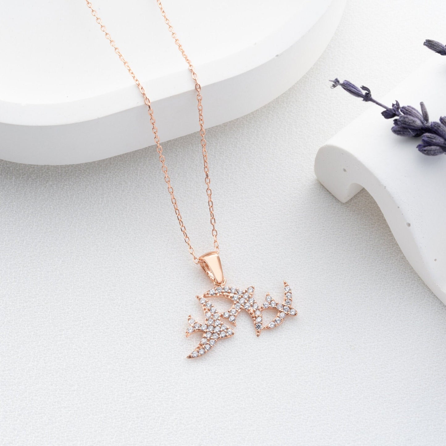 Elegant three seagulls silver necklace with sparkling zircon gemstones detail on a light background.