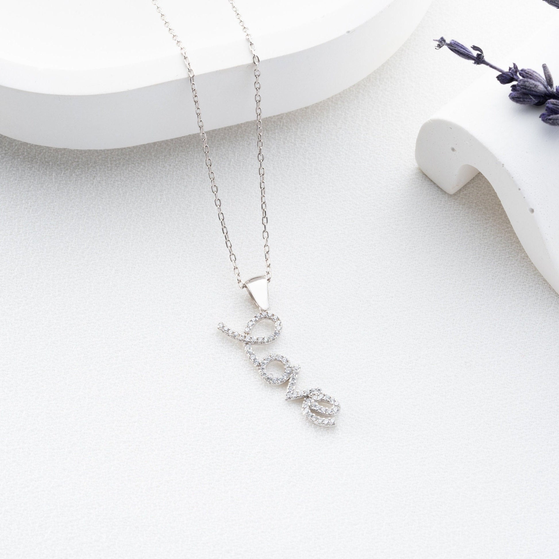 Handmade sterling silver; necklace with shimmering zircon stones delicately set along the word, reflecting elegance and romance