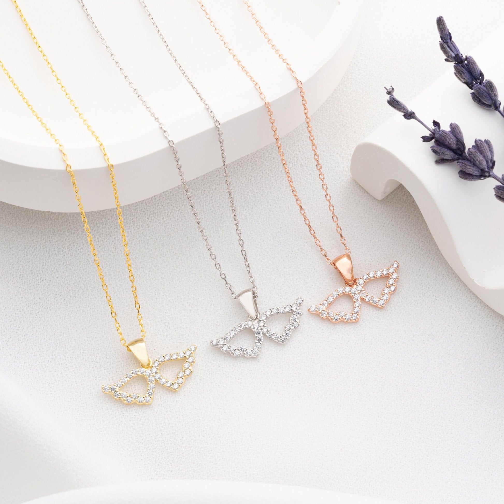 Elegant 925 sterling silver angel wing necklace, adorned with sparkling zircon stones, ideal as a protective charm or Mother&#39;s Day gift.
