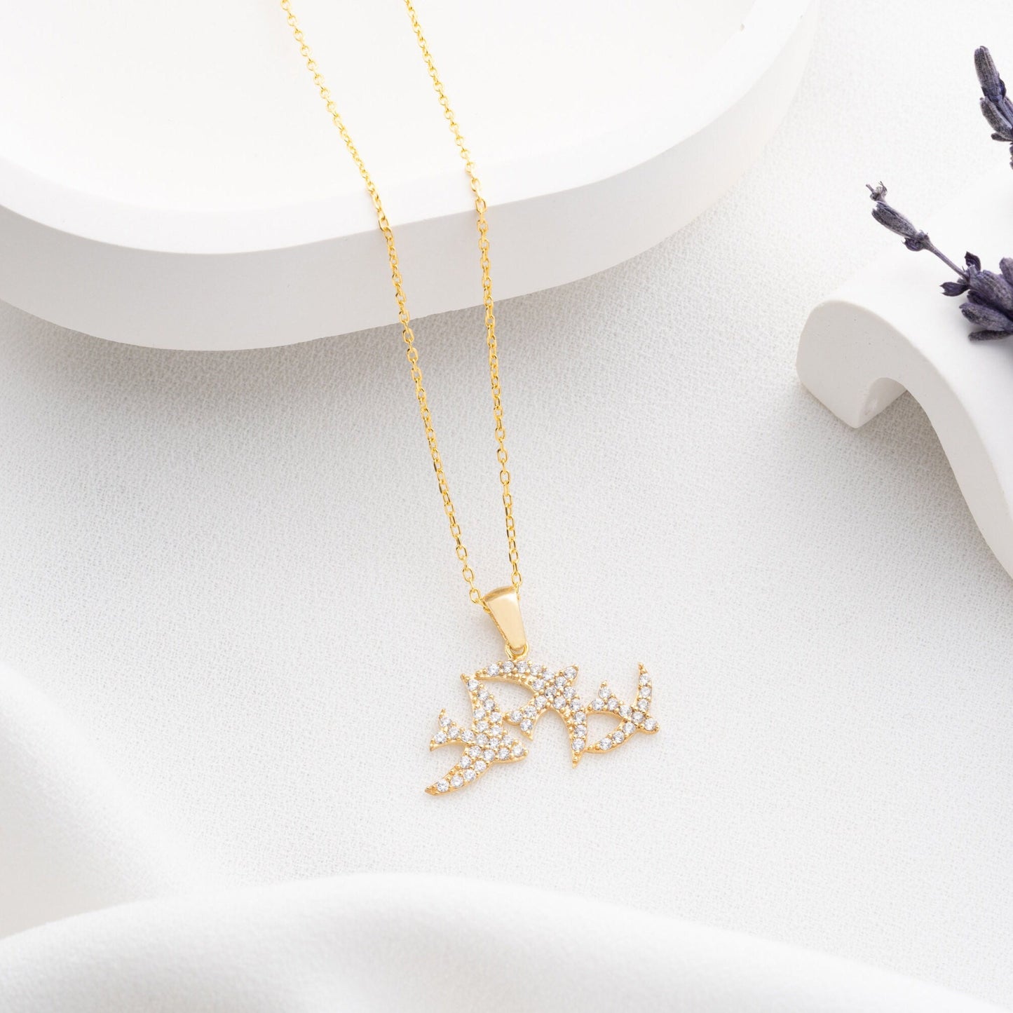 Elegant three seagulls silver necklace with sparkling zircon gemstones detail on a light background.