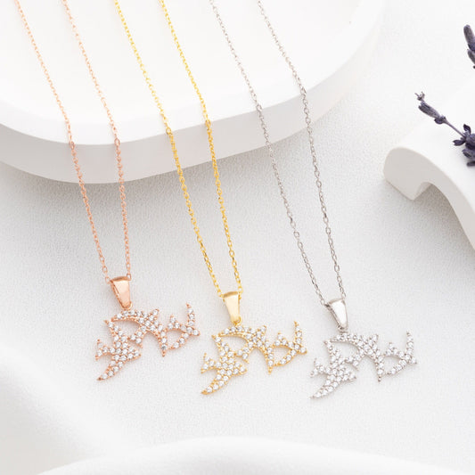 Elegant three seagulls silver necklace with sparkling zircon gemstones detail on a light background.