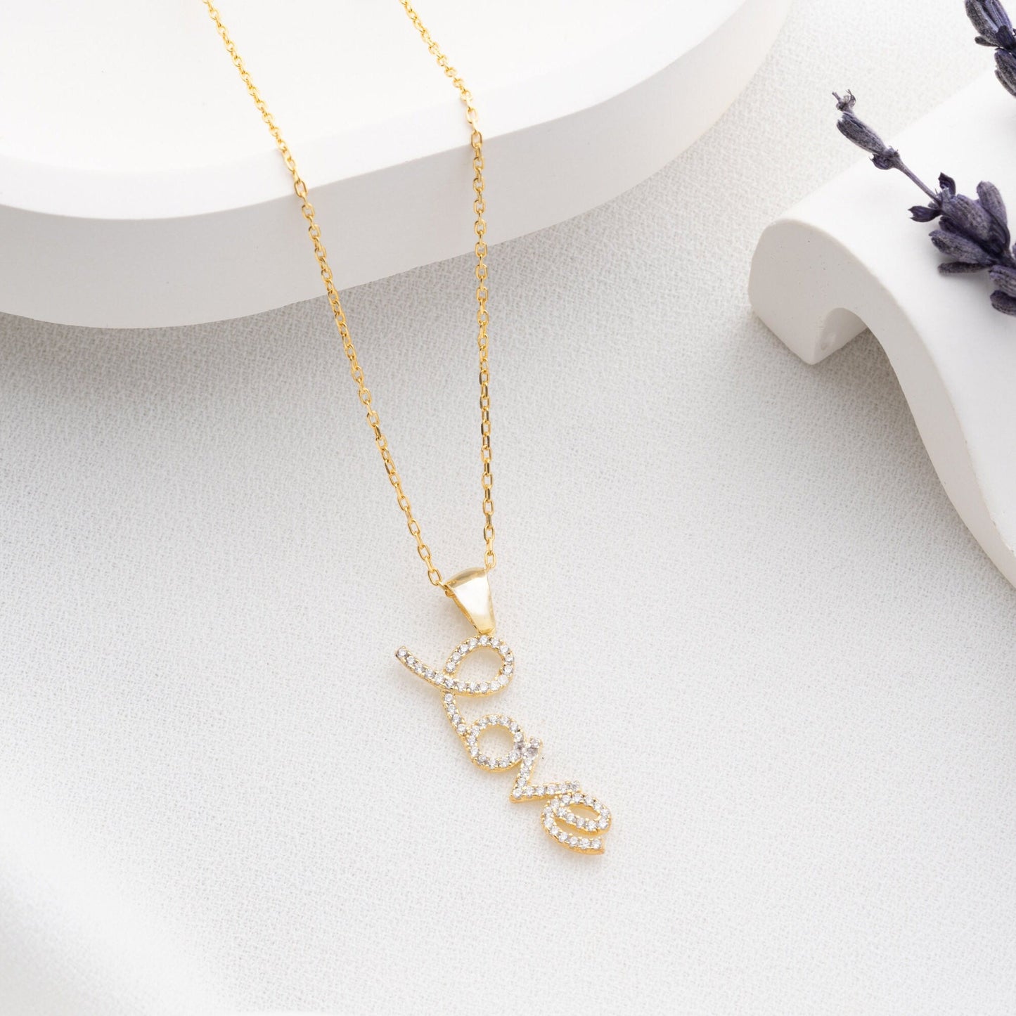 Handmade sterling silver; necklace with shimmering zircon stones delicately set along the word, reflecting elegance and romance