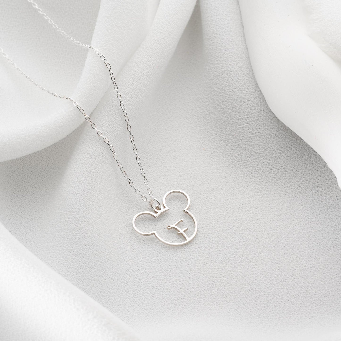 Custom initial necklace with a unique letter-in-pendant design, crafted in 925 sterling silver or 14k gold plated. A personalized and elegant handmade jewelry gift.