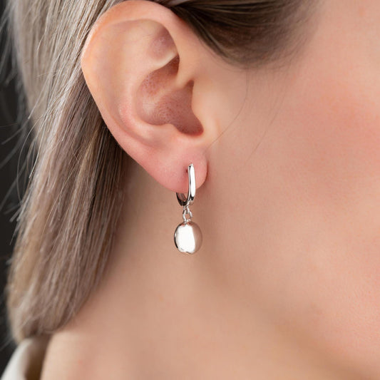 minimalist ball earrings in 925 sterling silver and 14K gold plated options, featuring a sleek design and lever-back closure displayed on a white marble background