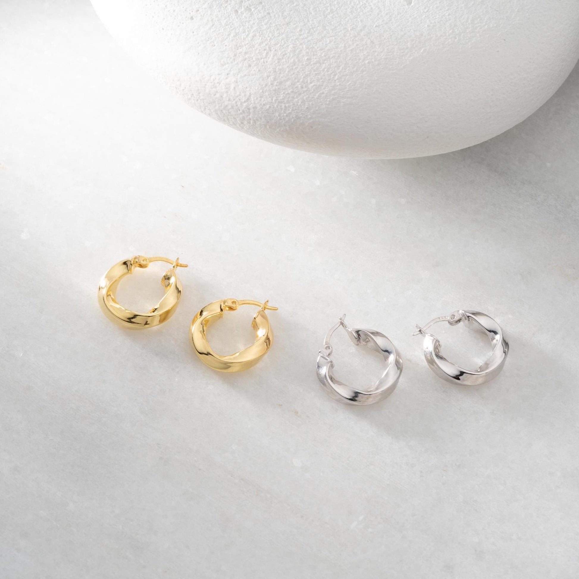 Twist hoop earrings in 925 Sterling Silver and 14K Gold Plated options, perfect for minimalist and elegant looks.