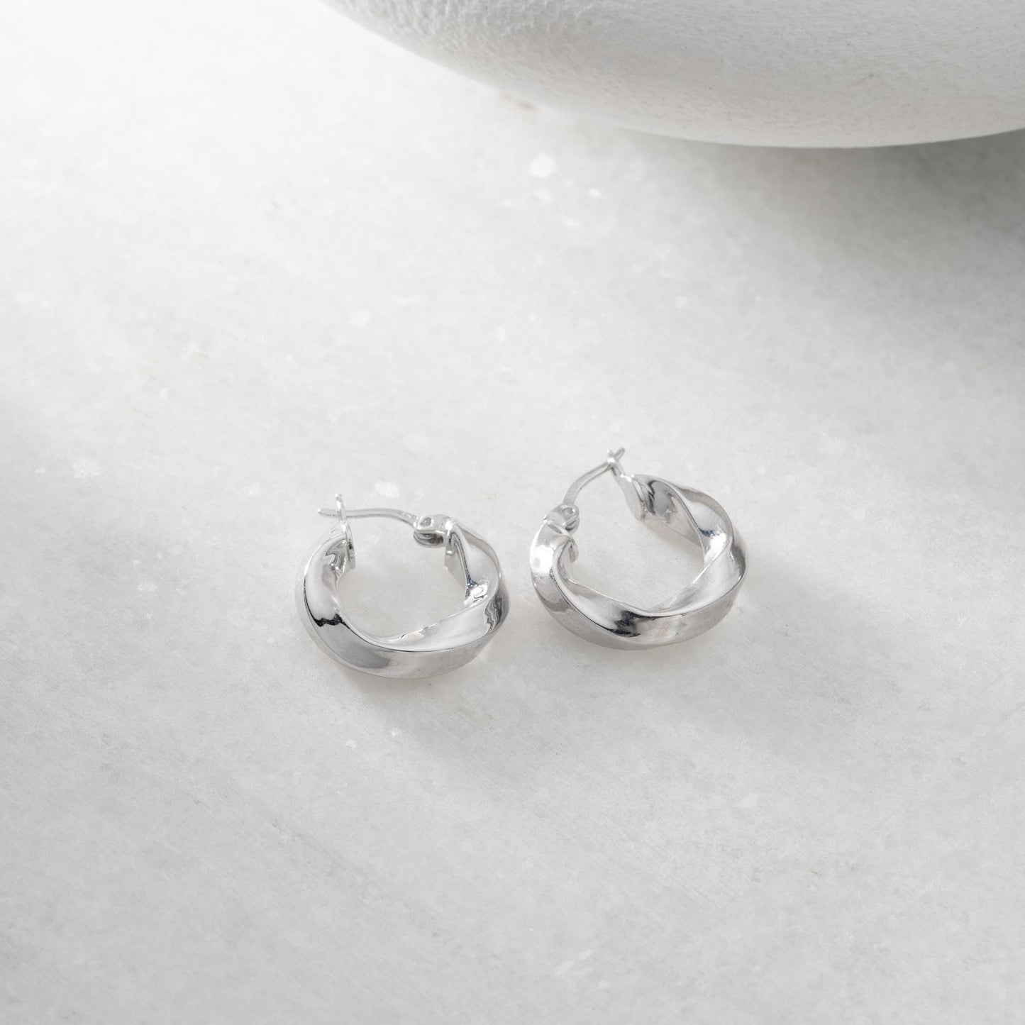 Twist hoop earrings in 925 Sterling Silver and 14K Gold Plated options, perfect for minimalist and elegant looks.