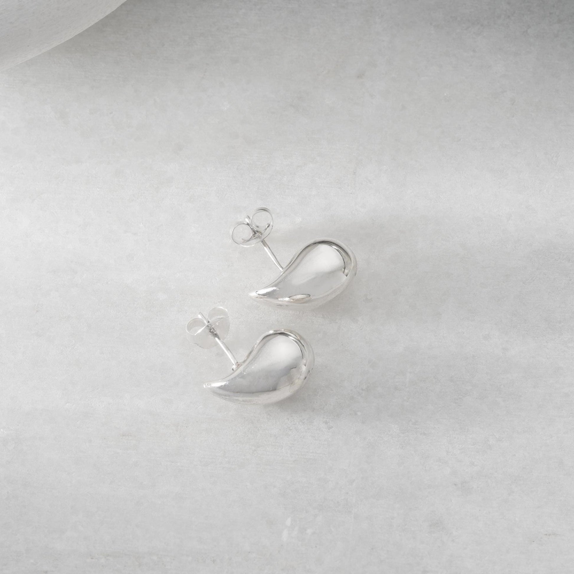 Teardrop-shaped stud earrings crafted from 925 sterling silver with a 14K gold-plated option, featuring a push back closure, perfect for Christmas gifting and everyday wear.