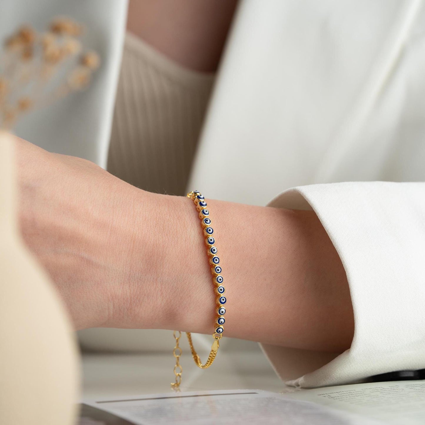 Evil eye bracelet crafted from 925 sterling silver with a 14K gold-plated option, featuring protective and stylish evil eye charms.