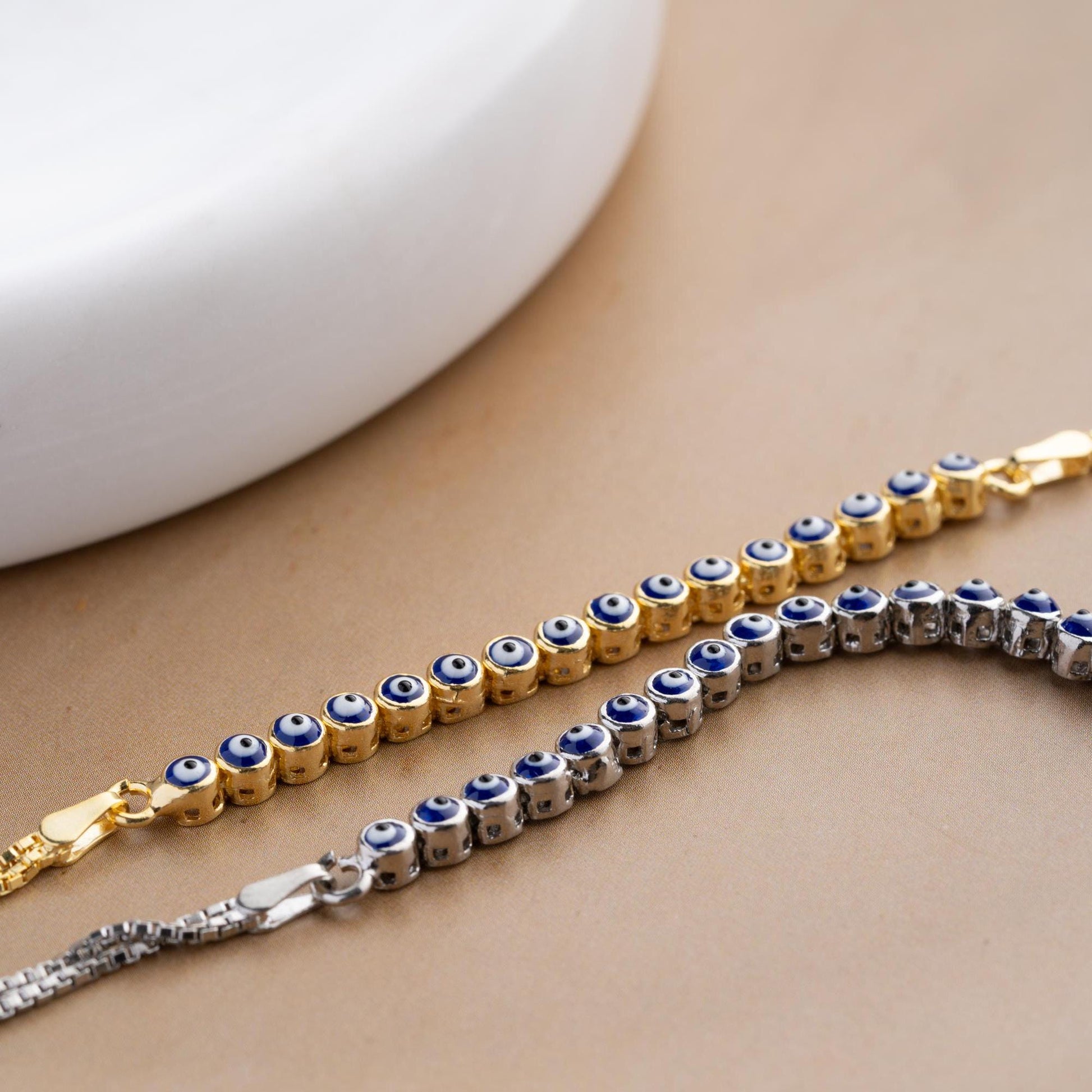 Evil eye bracelet crafted from 925 sterling silver with a 14K gold-plated option, featuring protective and stylish evil eye charms.