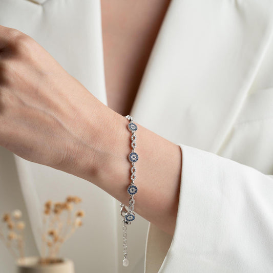 Infinity Evil Eye Bracelet with 925 Sterling Silver and 14K Gold Plated options, featuring blue evil eye accents, photographed in gold and silver variations.