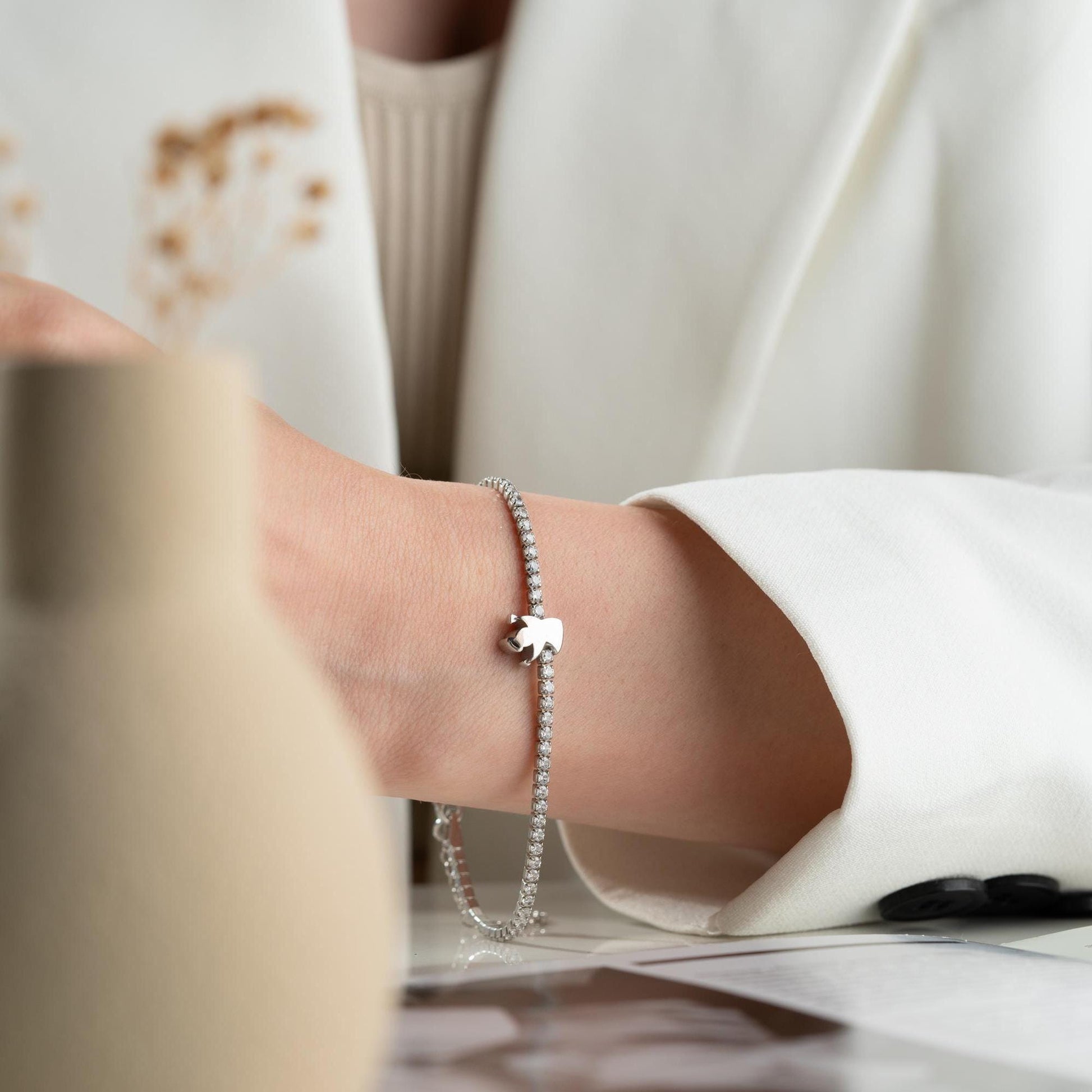 Angel Charm Bracelet in 925 Sterling Silver with a 14K Gold Plated angel charm and cubic zirconia stones, elegantly displayed.