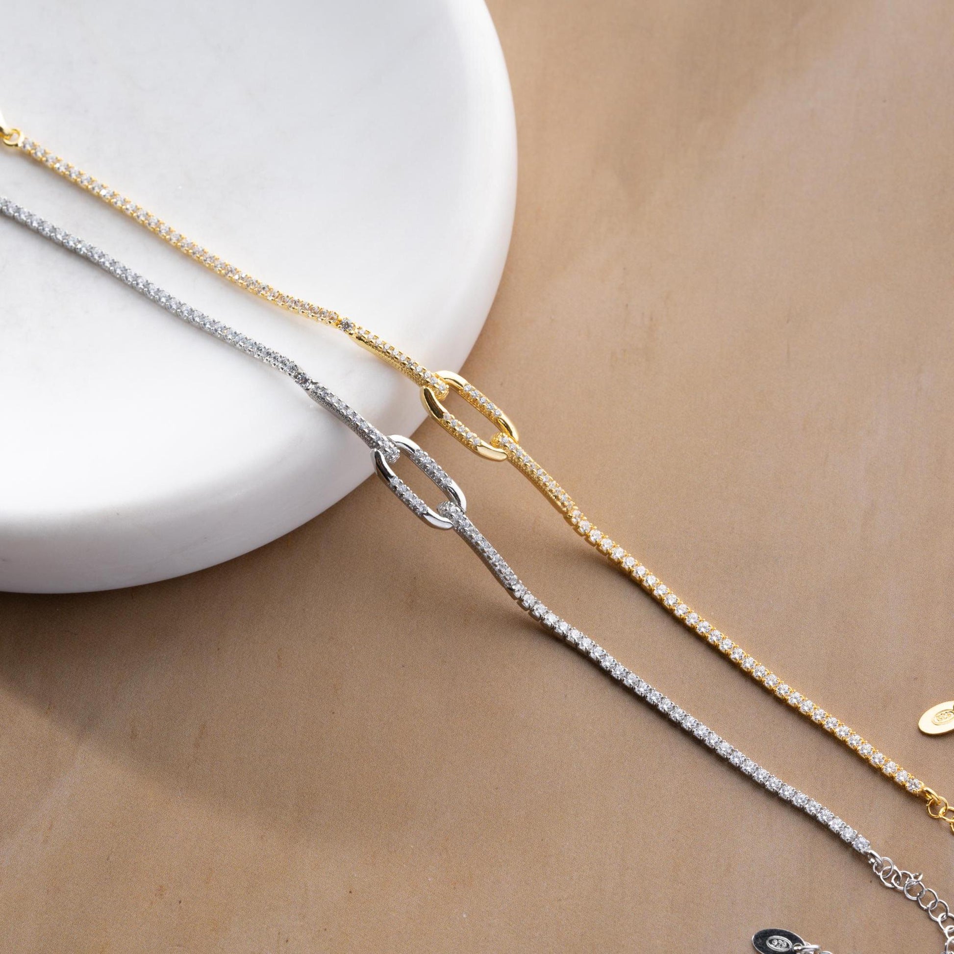 Elegant link chain tennis bracelet with cubic zirconia stones, crafted in 925 Sterling Silver and available in silver and gold finishes, perfect for festive gifting.
