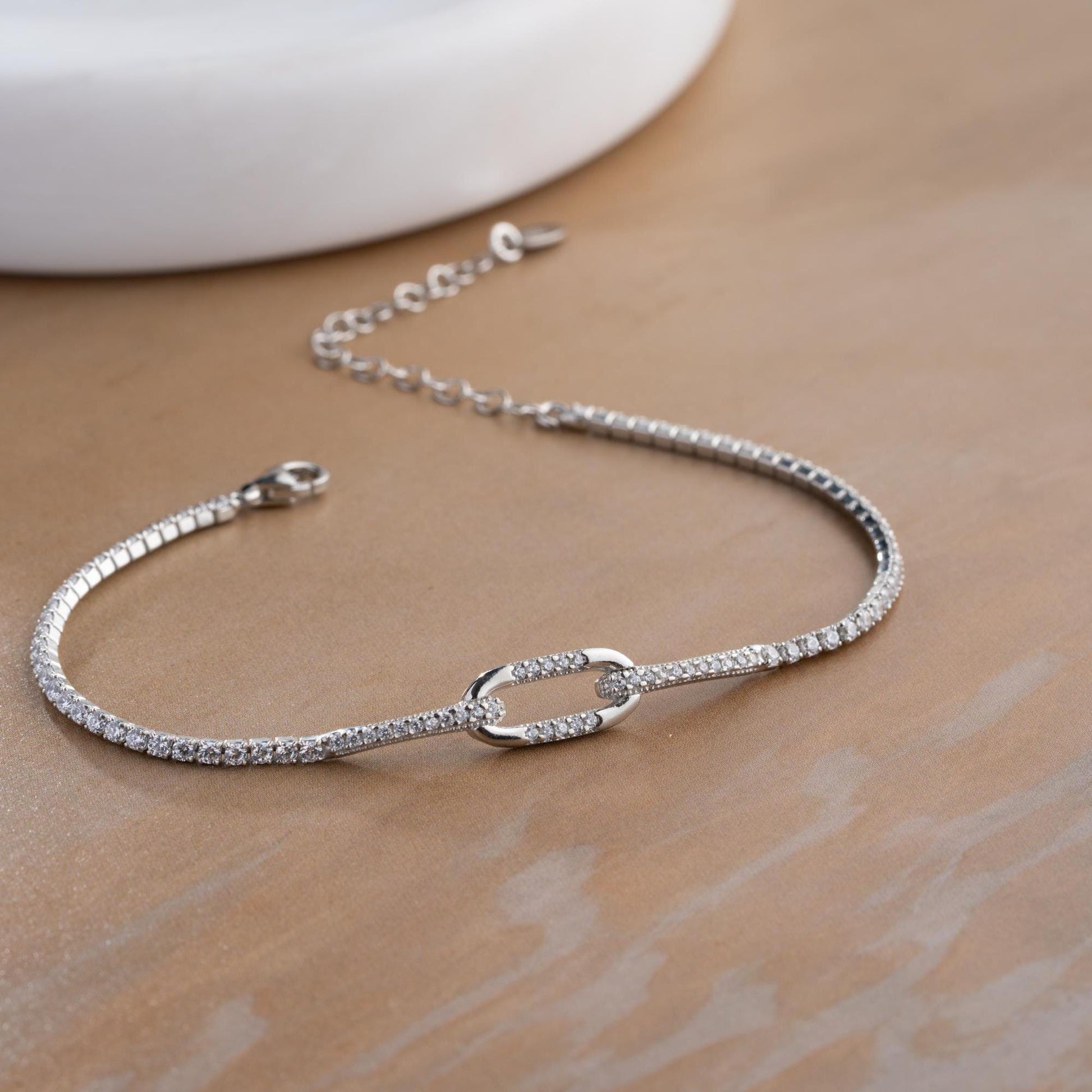 Elegant link chain tennis bracelet with cubic zirconia stones, crafted in 925 Sterling Silver and available in silver and gold finishes, perfect for festive gifting.