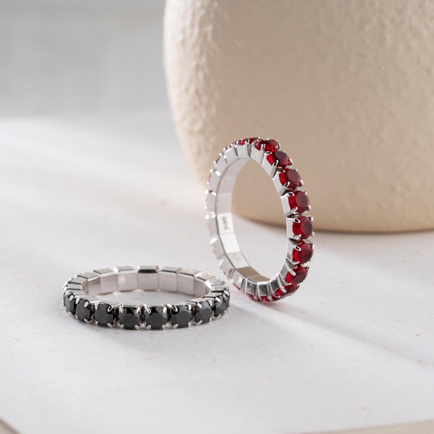 Single vibrant tennis ring crafted in 925 Sterling Silver with colorful cubic zirconia stones, available in rainbow, red, blue, green, black, and pink.