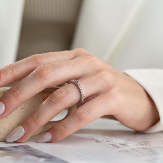 Elegant white zircon tennis ring made from 925 Sterling Silver, with brilliant stones set around the entire band. Adjustable and hypoallergenic.