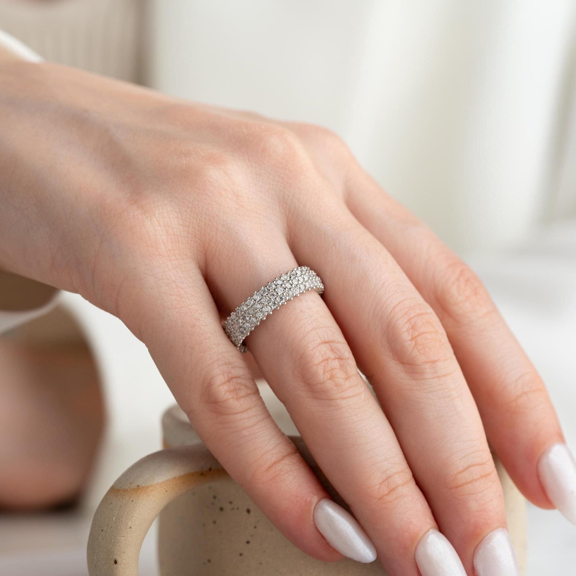 Full eternity band ring featuring pave cubic zirconia stones in clear and turquoise options, set in 925 sterling silver. A versatile, stackable piece perfect for gifting or personal wear.