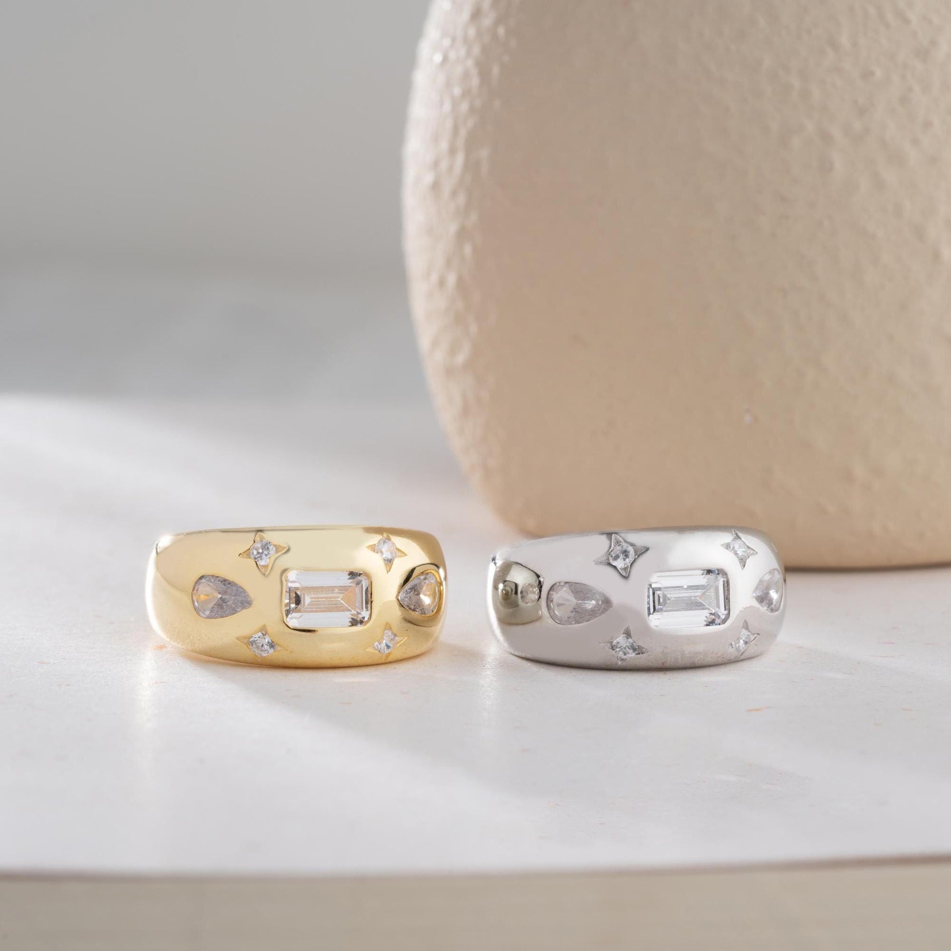 Baguette and teardrop cubic zirconia band ring in 925 sterling silver and 14K gold plating, featuring celestial star motifs. Elegant statement ring for women.