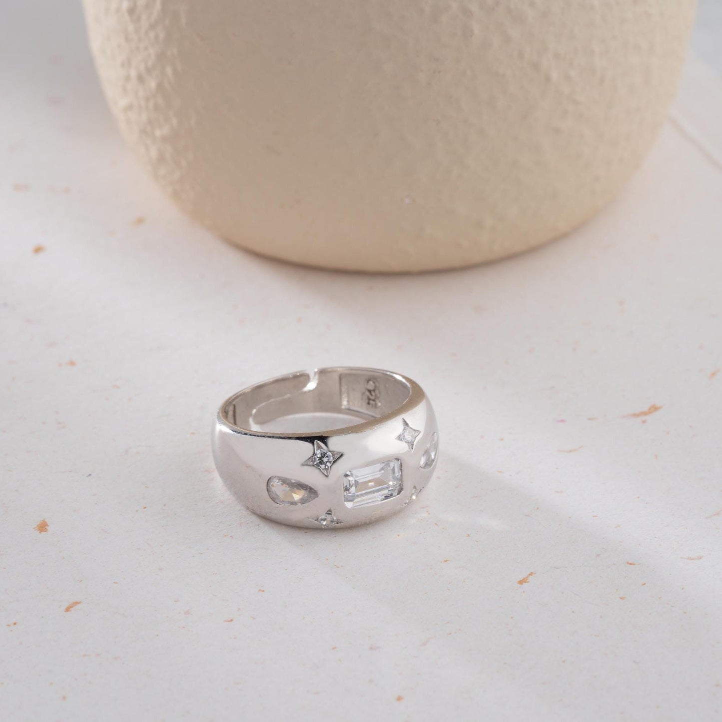 Baguette and teardrop cubic zirconia band ring in 925 sterling silver and 14K gold plating, featuring celestial star motifs. Elegant statement ring for women.
