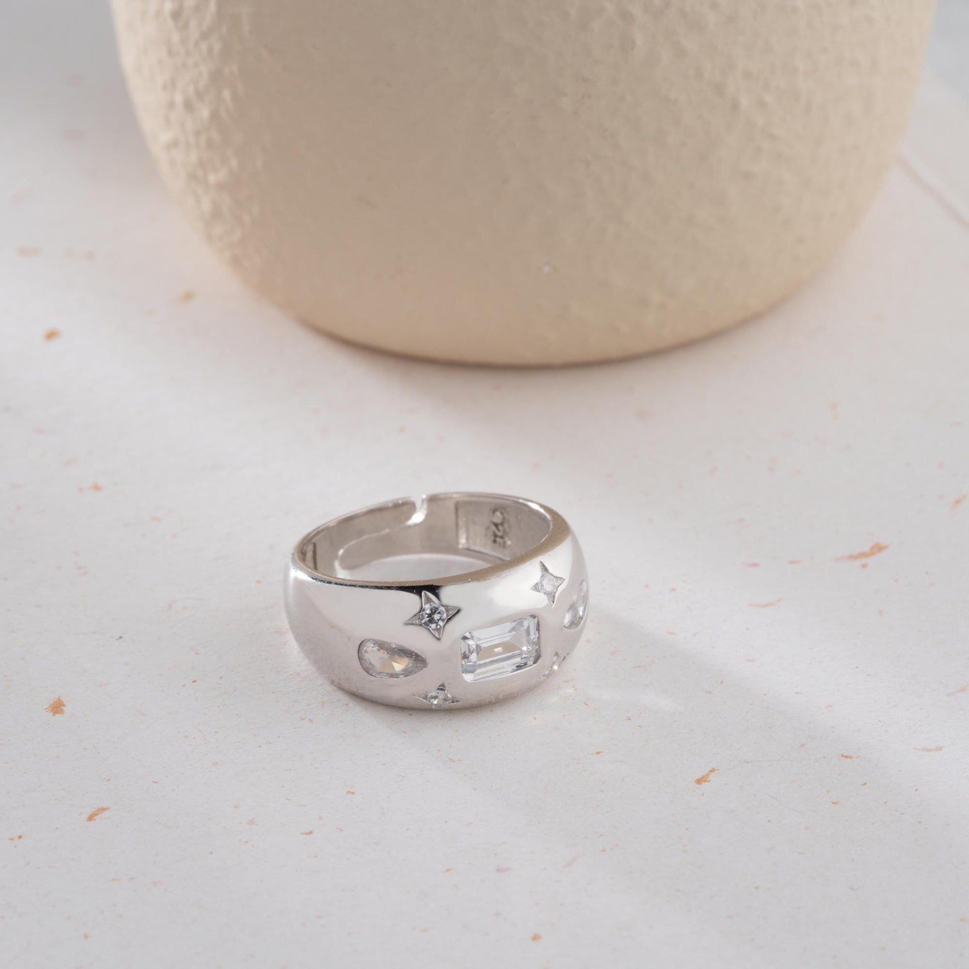 Baguette and teardrop cubic zirconia band ring in 925 sterling silver and 14K gold plating, featuring celestial star motifs. Elegant statement ring for women.