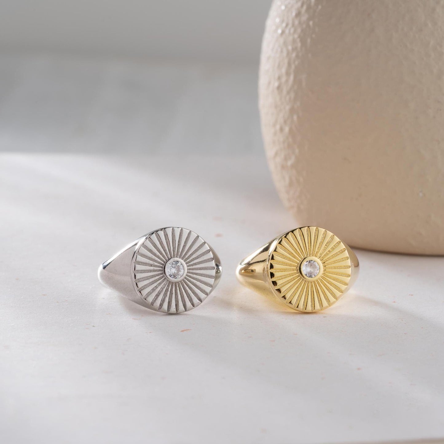 Sunburst engraved statement ring in 925 sterling silver and 14K gold plating with a center cubic zirconia stone.