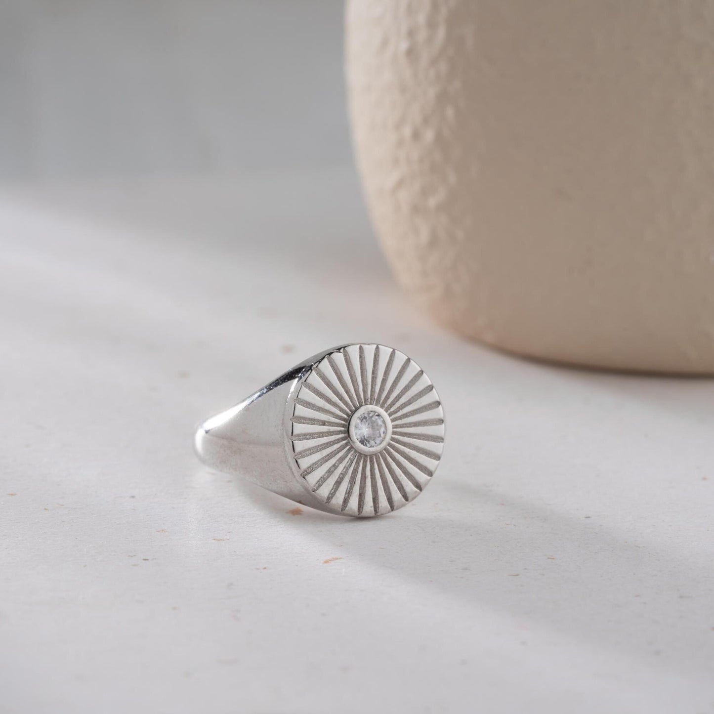 Sunburst engraved statement ring in 925 sterling silver and 14K gold plating with a center cubic zirconia stone.
