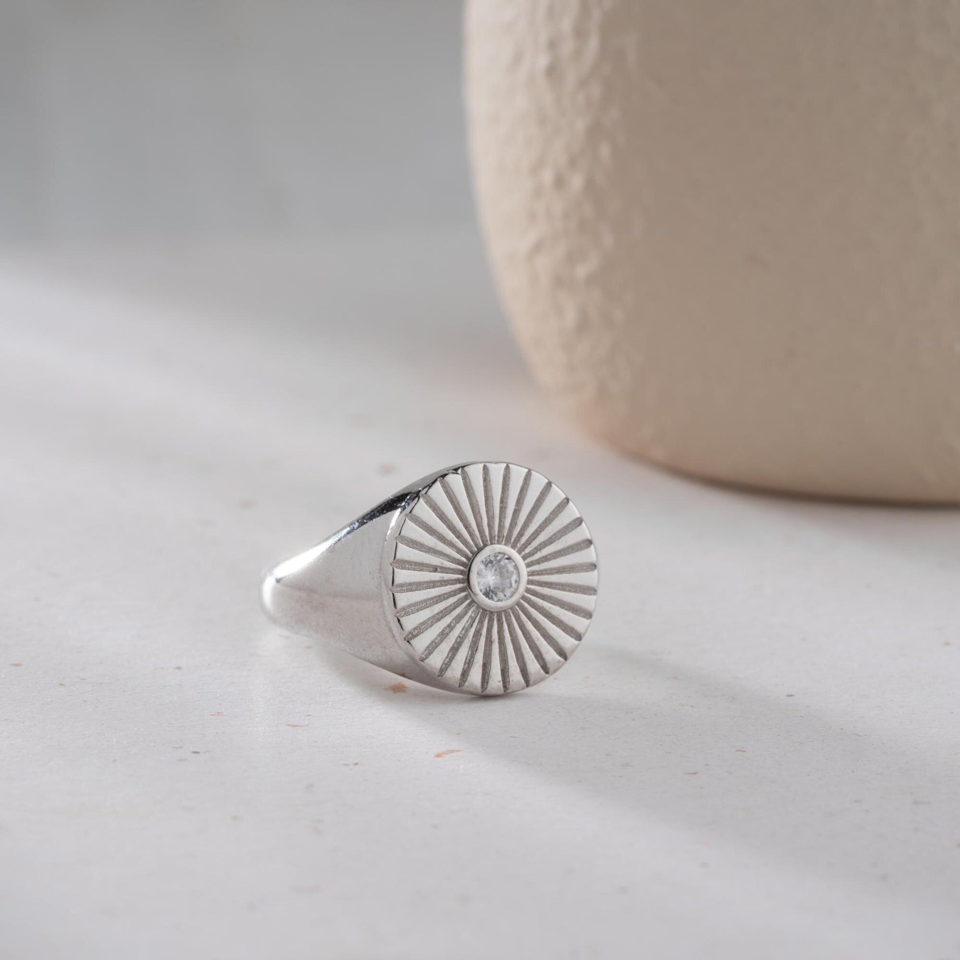 Sunburst engraved statement ring in 925 sterling silver and 14K gold plating with a center cubic zirconia stone.