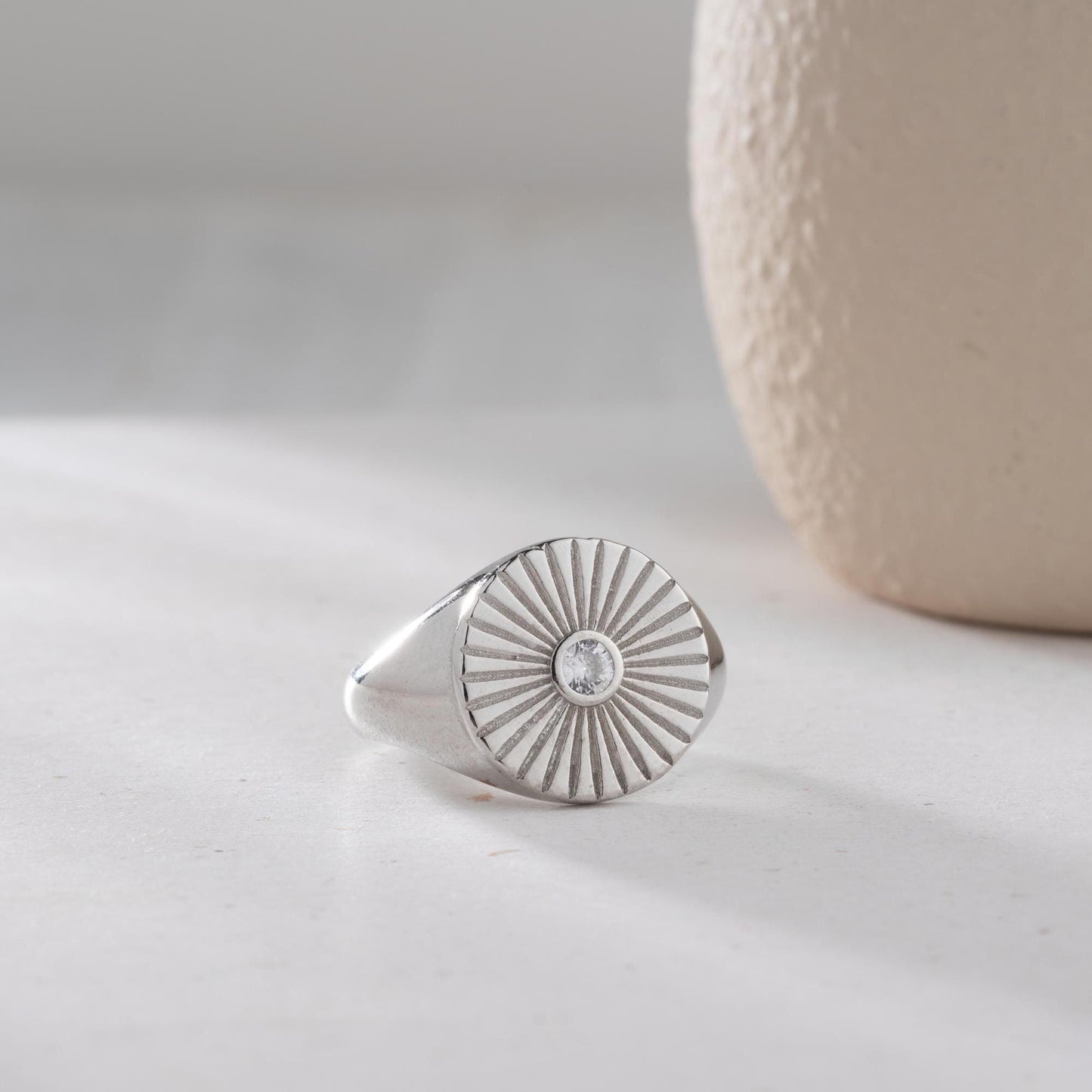 Sunburst engraved statement ring in 925 sterling silver and 14K gold plating with a center cubic zirconia stone.