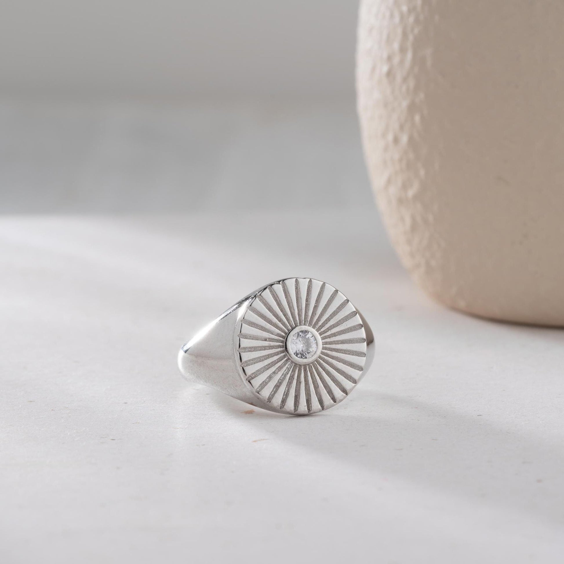 Sunburst engraved statement ring in 925 sterling silver and 14K gold plating with a center cubic zirconia stone.