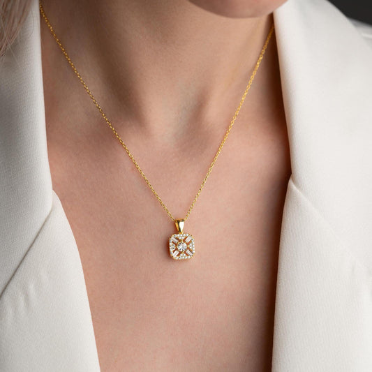 Square pendant necklace with cubic zirconia stones, available in 925 sterling silver and 14K gold plated options, displayed on a white satin background
