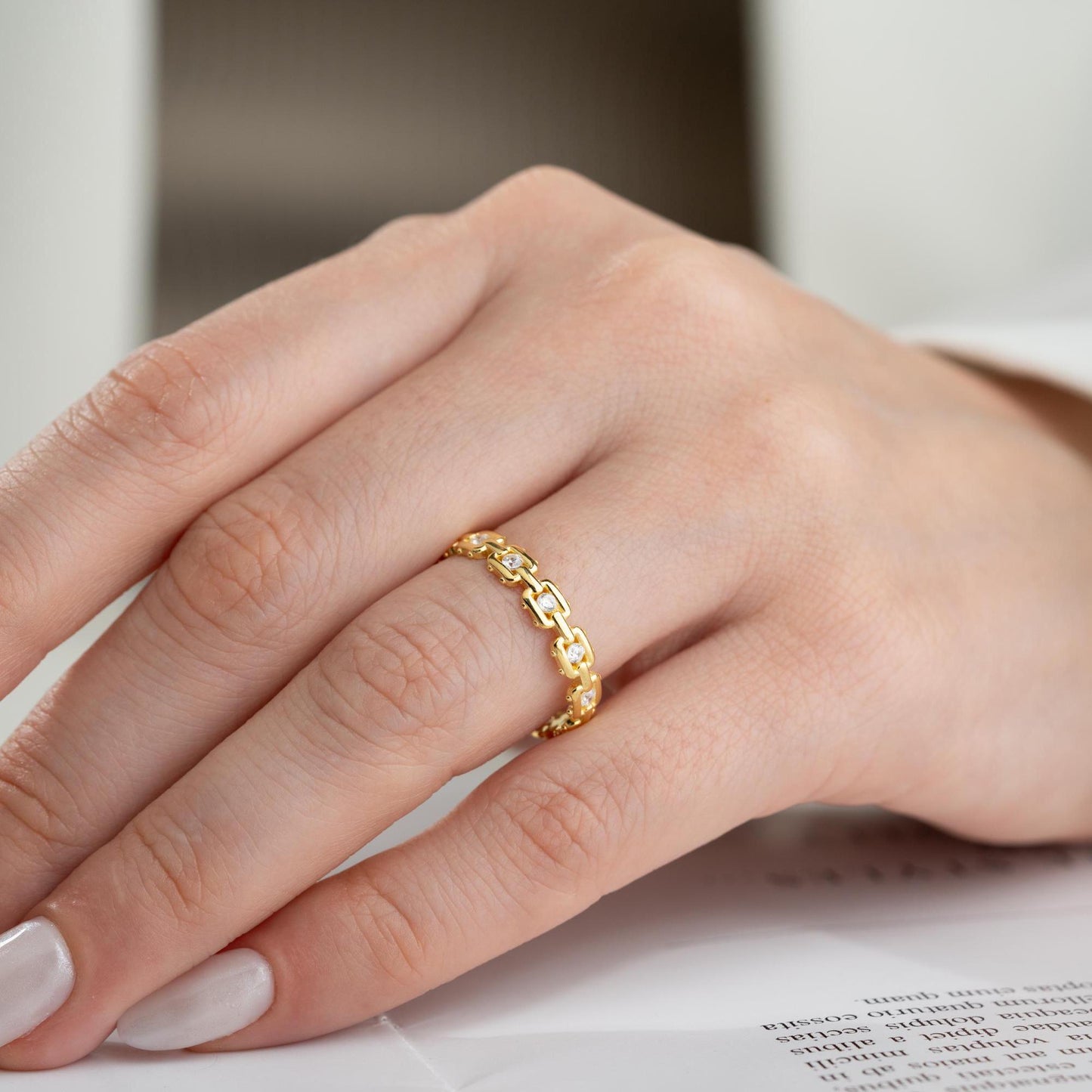 A dazzling chain link eternity ring with cubic zirconia stones, handcrafted from 925 sterling silver and available in silver or 14K gold plated finishes. Ideal for birthdays, anniversaries, and gifts for her.