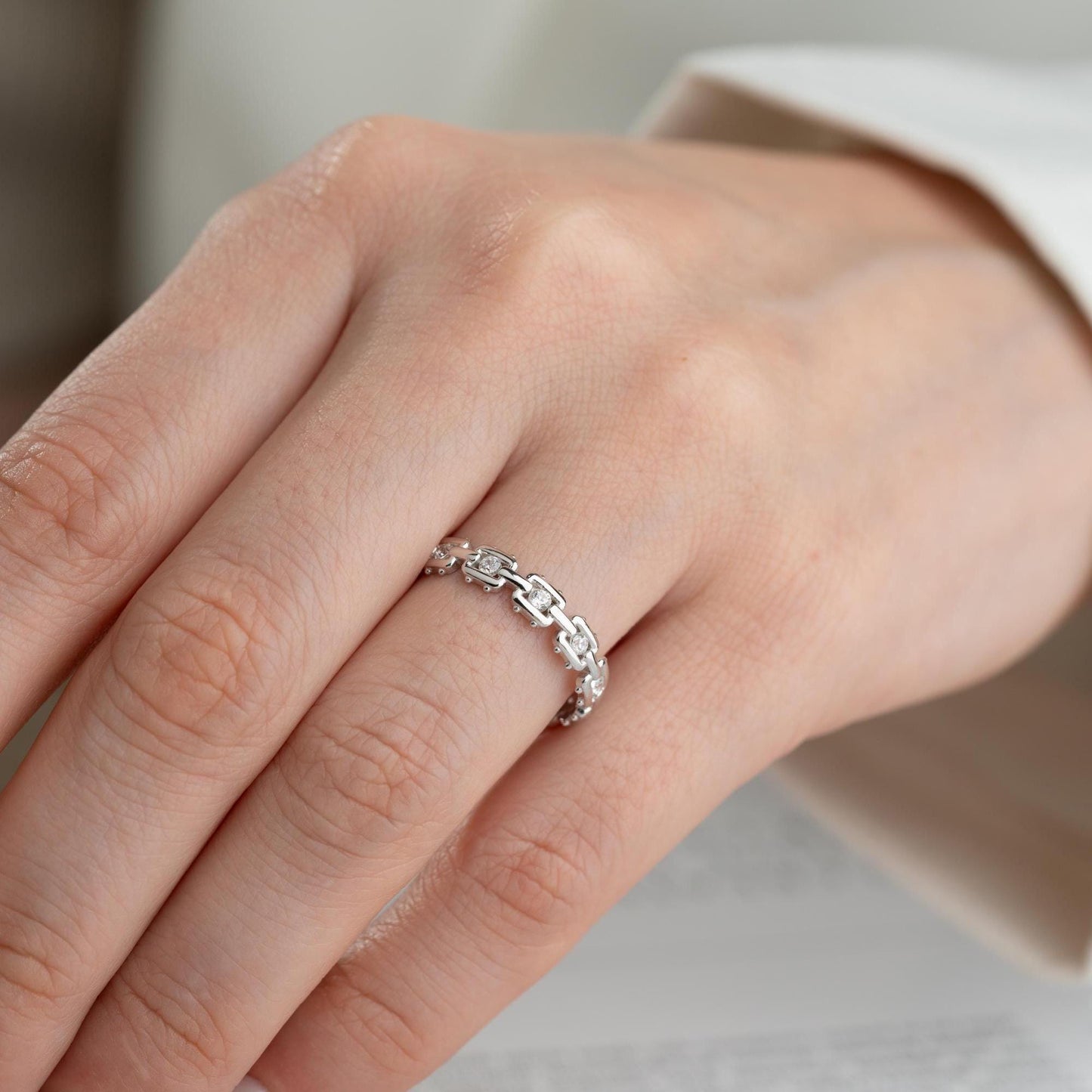 A dazzling chain link eternity ring with cubic zirconia stones, handcrafted from 925 sterling silver and available in silver or 14K gold plated finishes. Ideal for birthdays, anniversaries, and gifts for her.