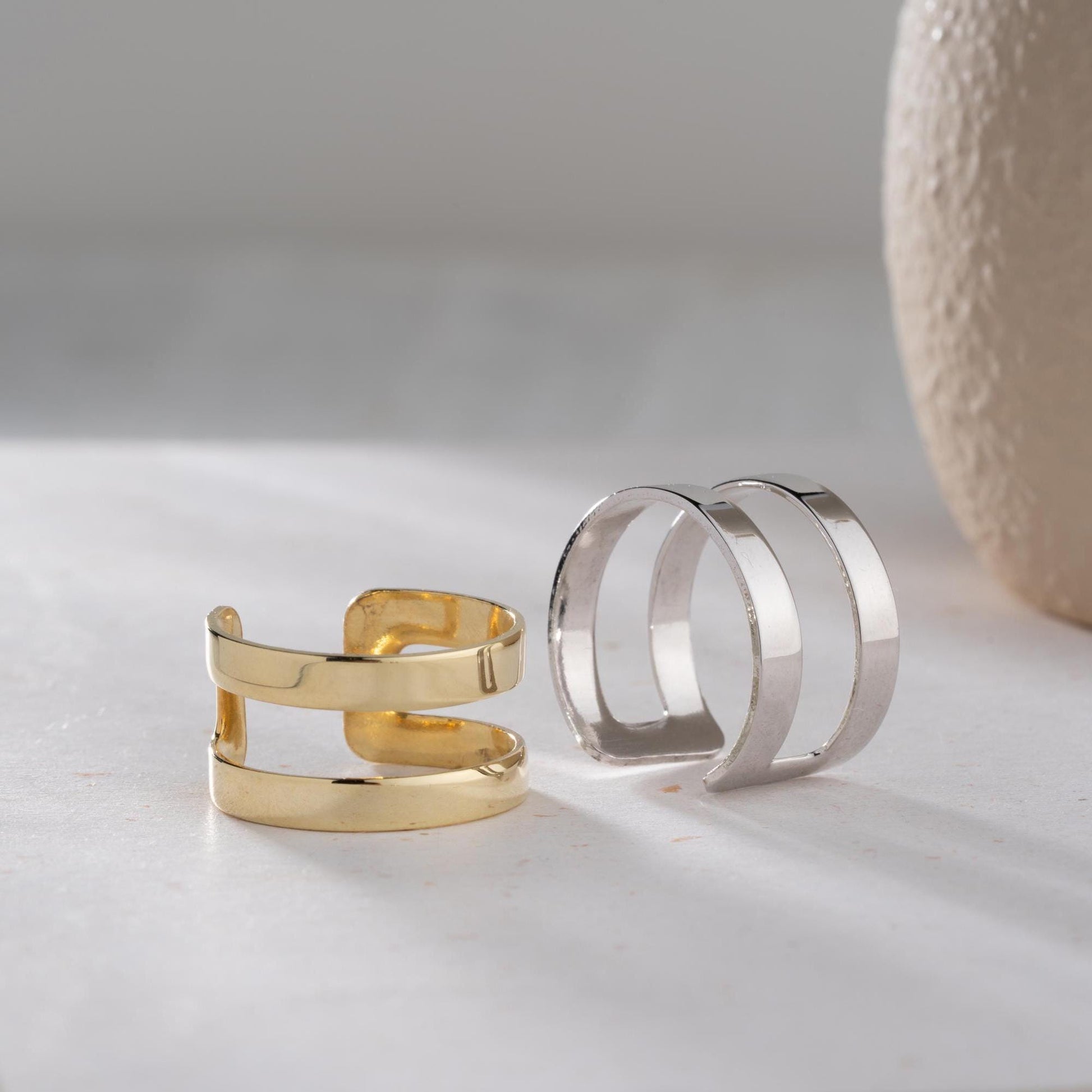 A sleek minimalist double-band ring, handcrafted from 925 sterling silver with 14K gold and rose gold plated options. A perfect stackable jewelry piece for everyday wear or as a gift for her.