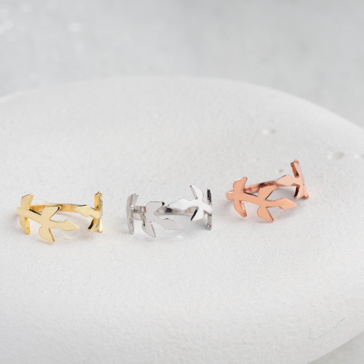 A delicate olive branch-inspired ring crafted from 925 Sterling Silver, available in gold and rose gold plating. Adjustable open band, perfect for nature lovers and elegant gifting.