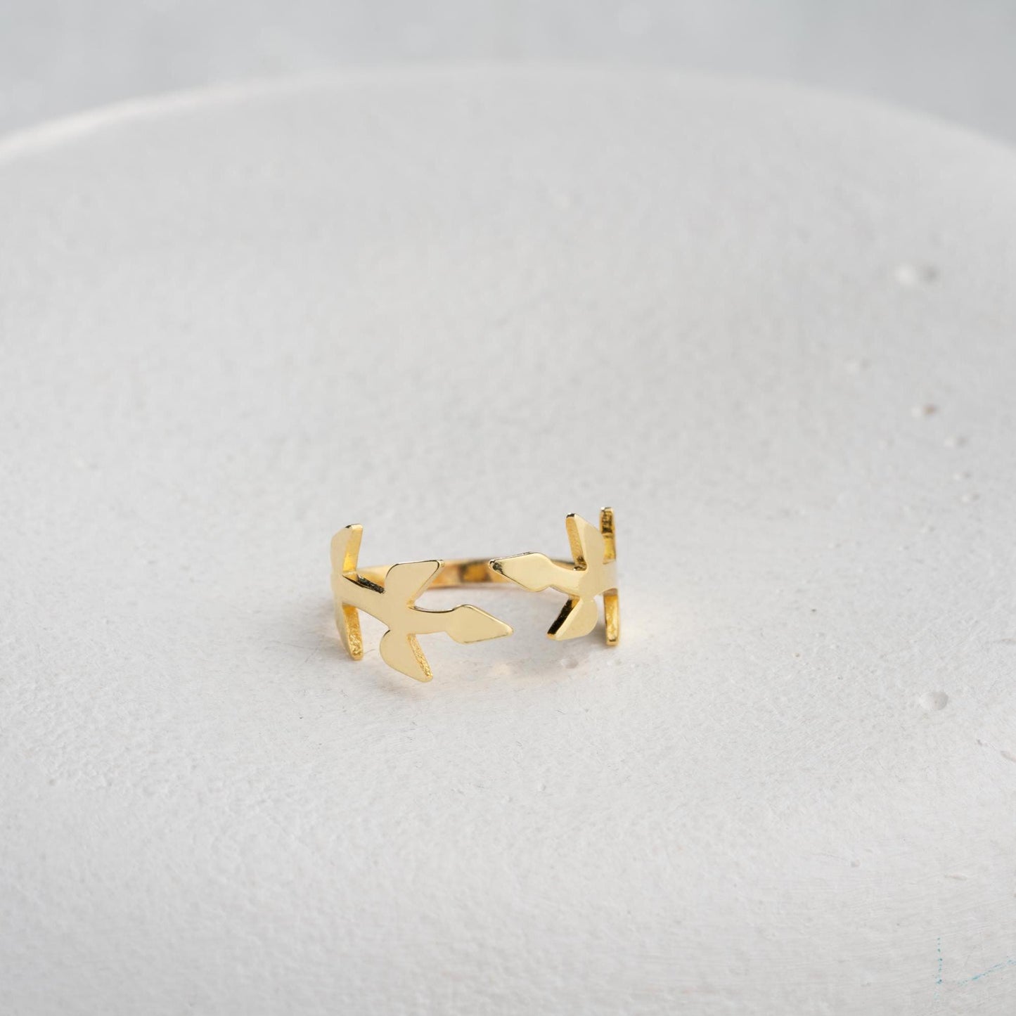 A delicate olive branch-inspired ring crafted from 925 Sterling Silver, available in gold and rose gold plating. Adjustable open band, perfect for nature lovers and elegant gifting.