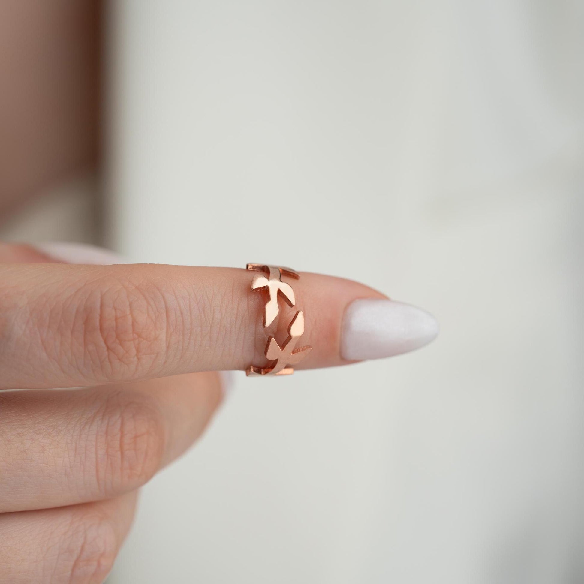 A delicate olive branch-inspired ring crafted from 925 Sterling Silver, available in gold and rose gold plating. Adjustable open band, perfect for nature lovers and elegant gifting.