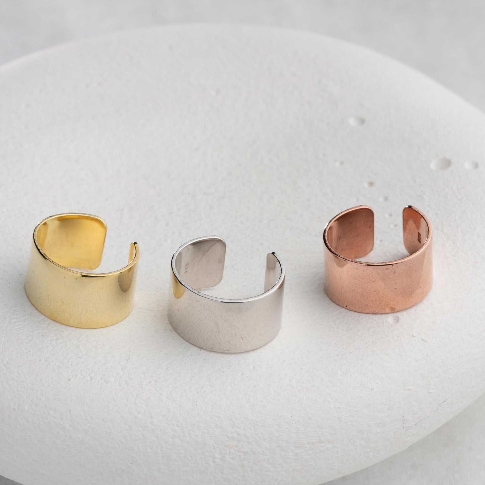 A bold, wide band open ring crafted from 925 Sterling Silver, available in gold and rose gold finishes. Adjustable design for comfort and style, ideal for gifting.