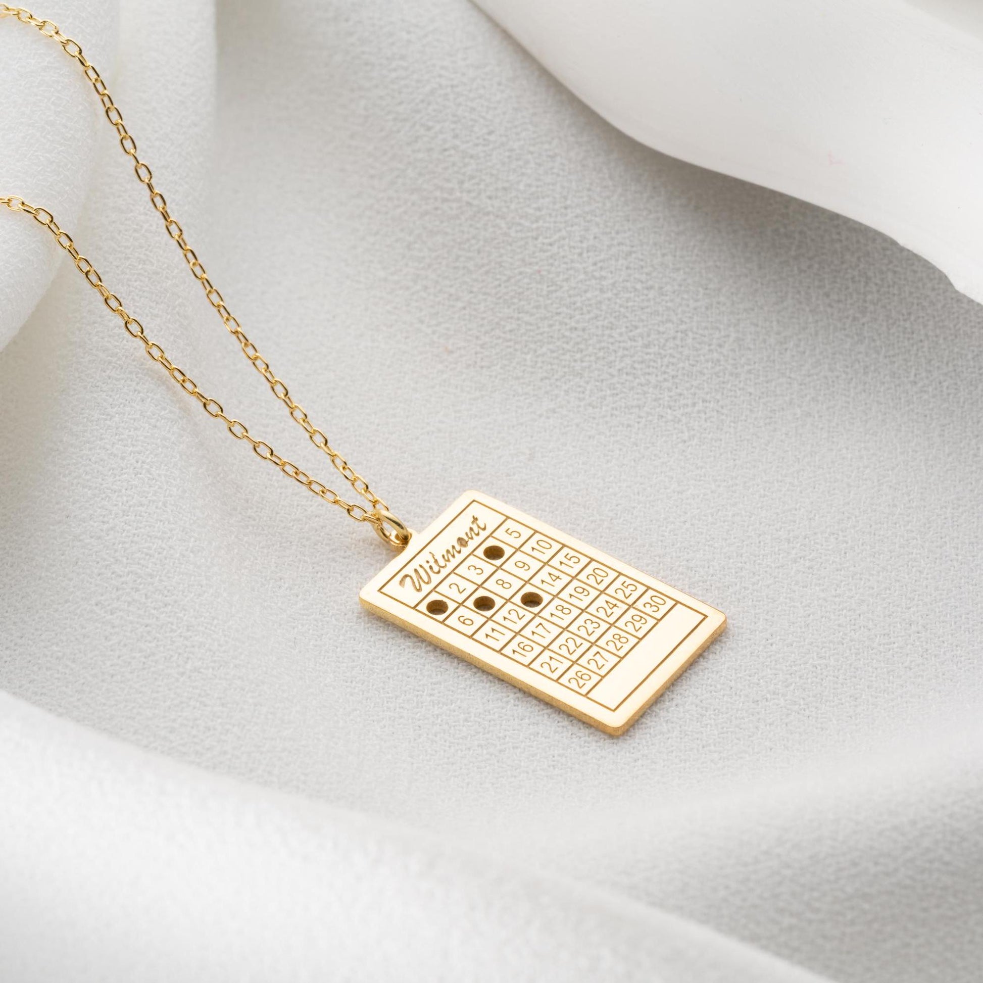 A rectangular calendar pendant necklace, engraved with a custom date and name, crafted from 925 Sterling Silver or 14K Gold Plated. Ideal for anniversaries, weddings, and birthday gifts.